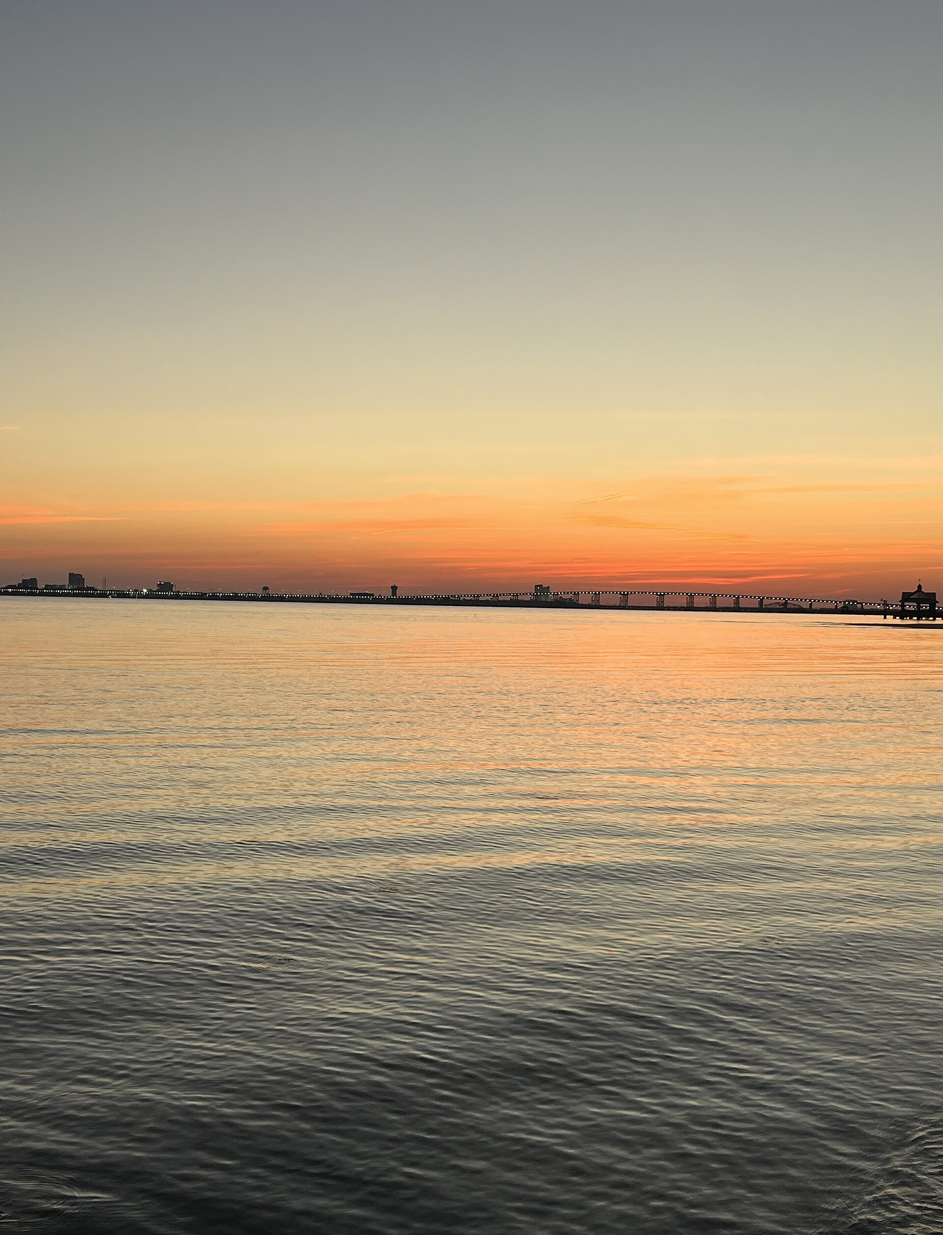 Bright orange sunset at East Beach in Ocean Springs, Mississippi